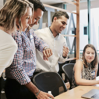 Principal and staff working over a computer